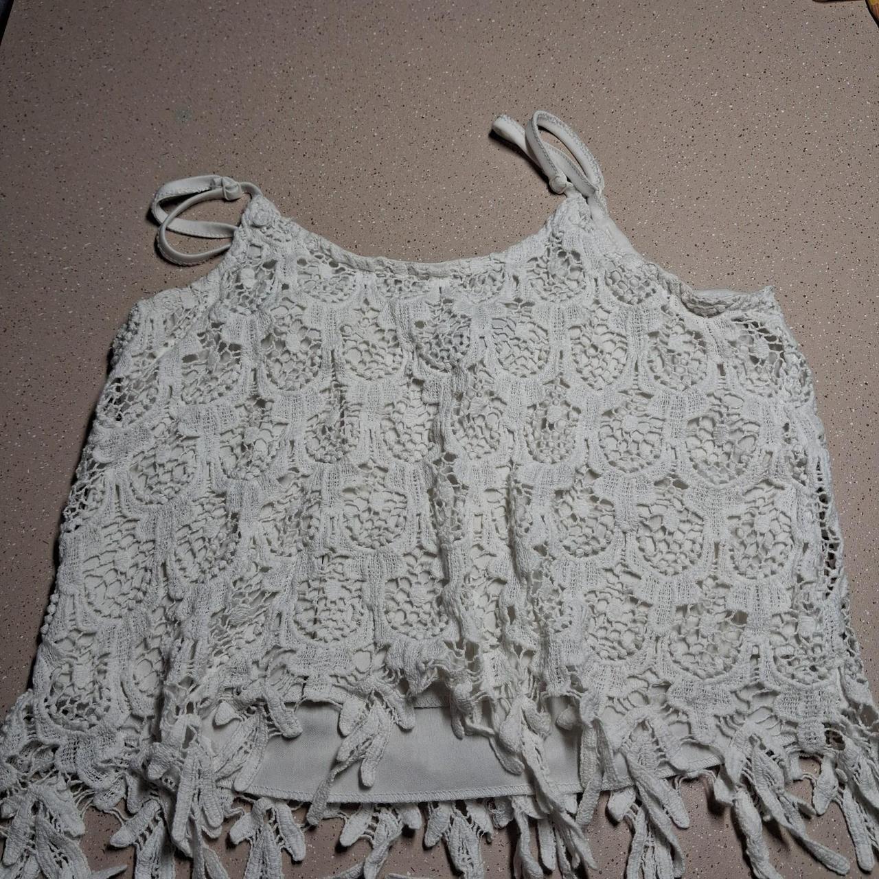White crochet crop top with floral and leaf motifs...