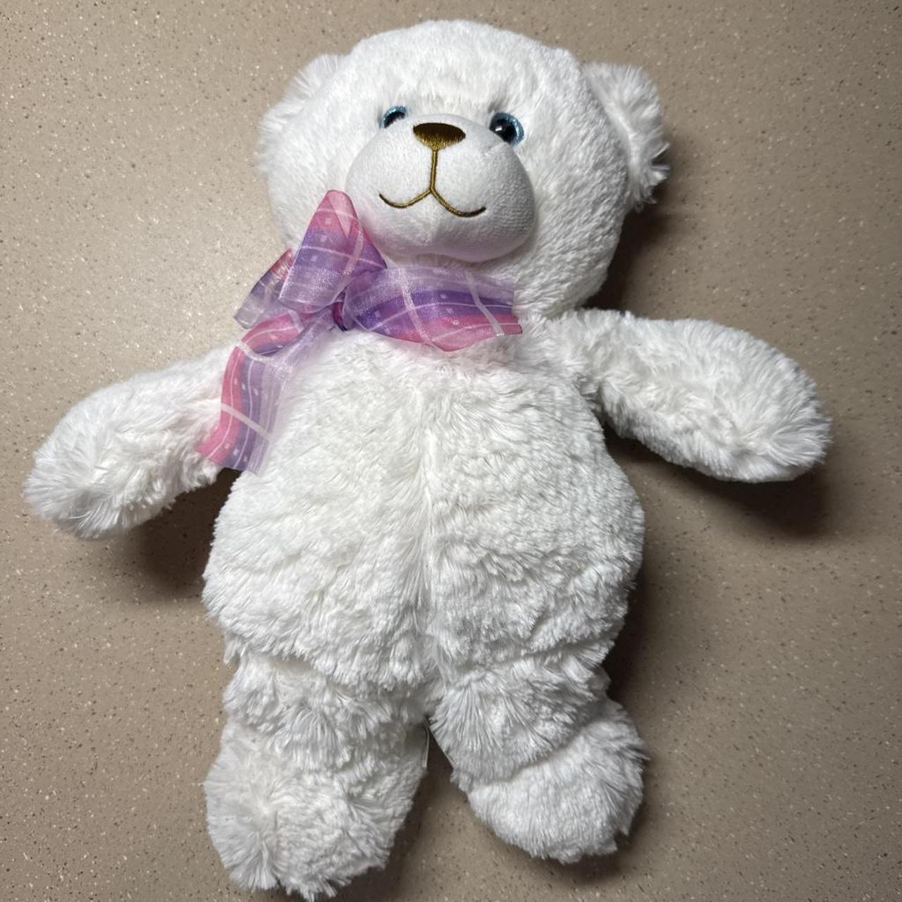 White teddy bear with pink and purple plaid bow...