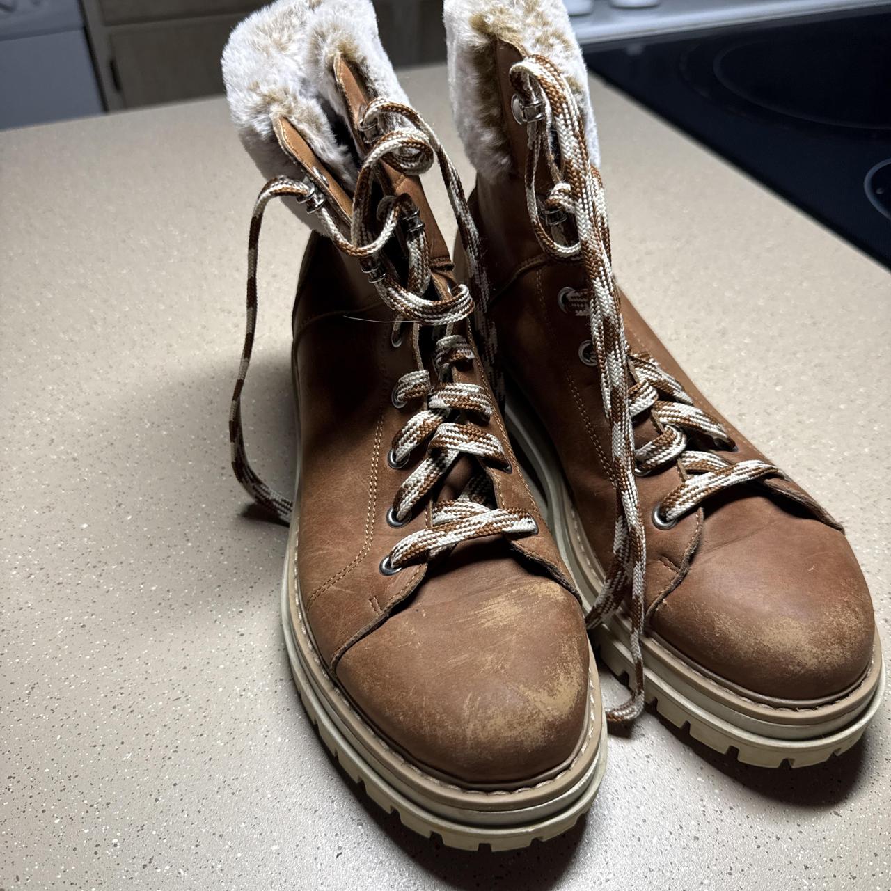 Brown leather lace-up boots with fur lining...