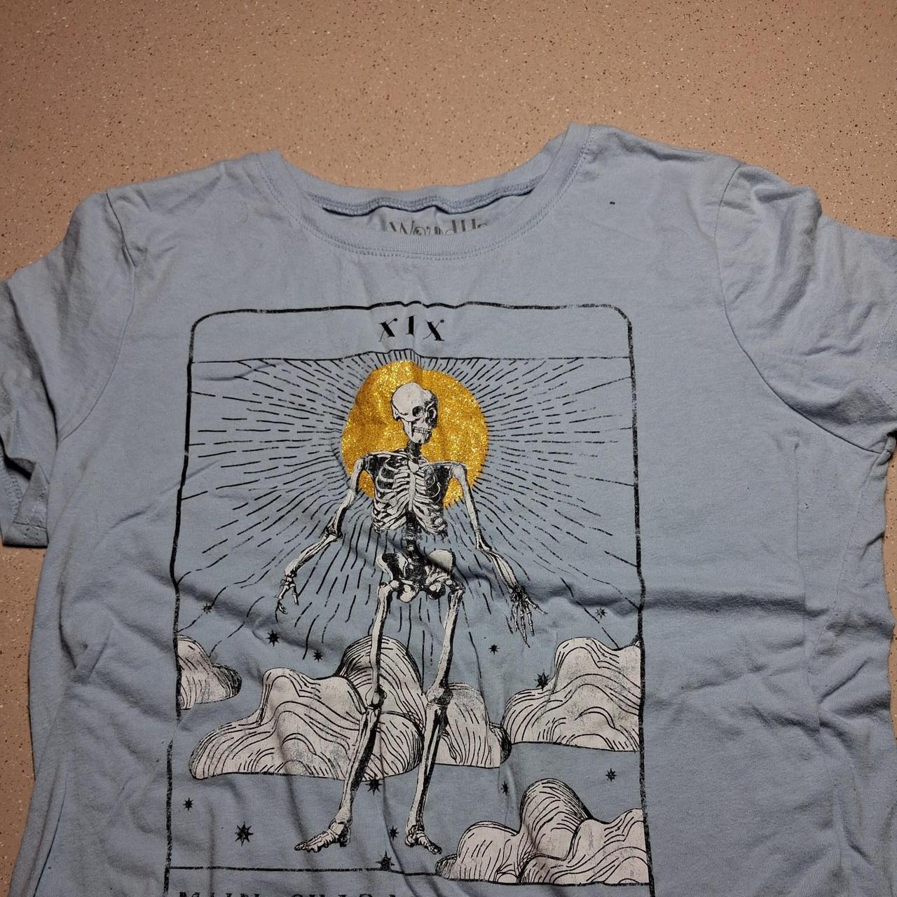 Wound Up blue skeleton tee with tarot card design...