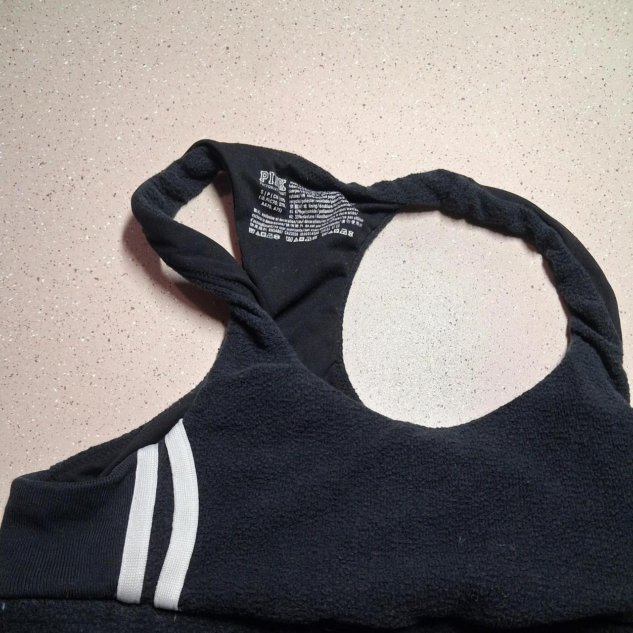 Black &amp; white sports bra with white stripes on the...