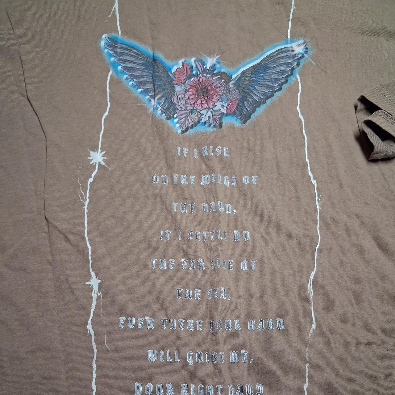 Brown graphic tee with blue wings and pink flower...