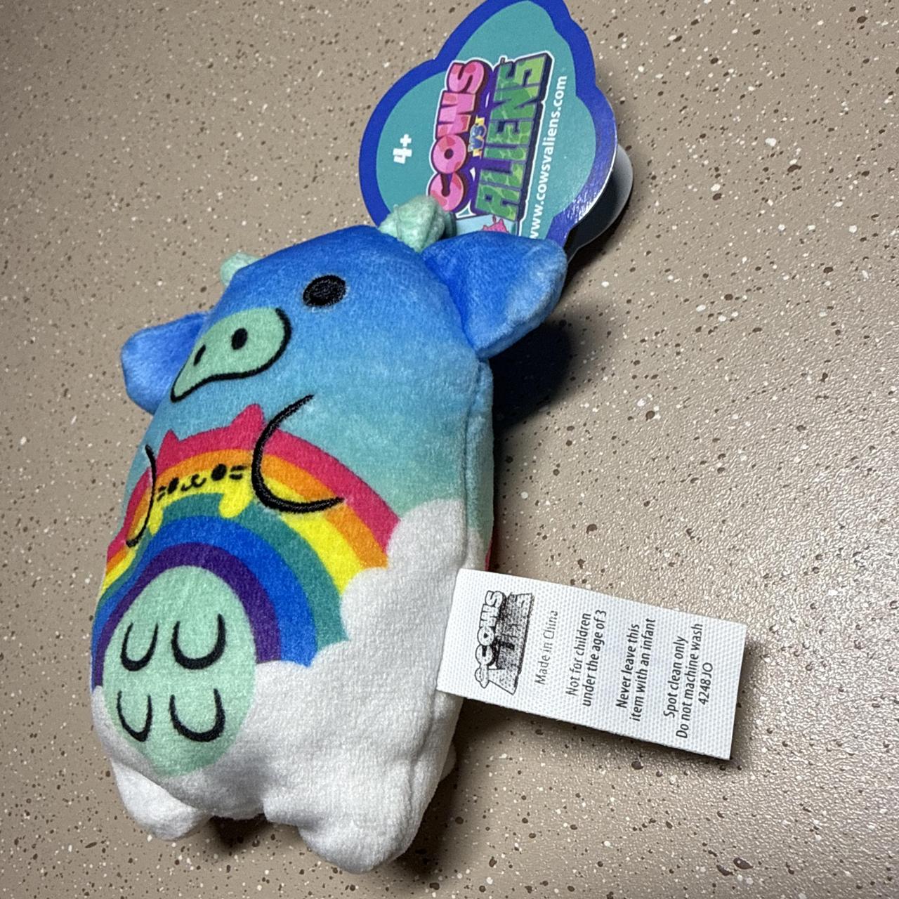 Rainmeow Cow plushie with rainbow and clouds design...
